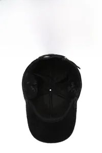 Detail view of thickened faux fur lining for winter warmth inside the black baseball cap