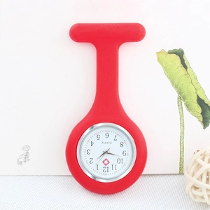 Detail view of a red silicone nurse fob watch with quartz movement and heart cross logo