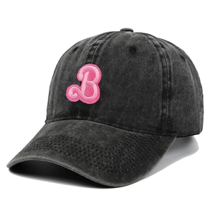 Close-up of pink towel embroidered letter B on a black washed cotton baseball cap