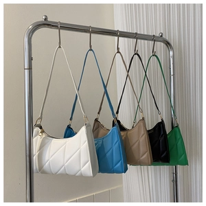 Quilted underarm bags in five colors hanging on a silver metal rack for display