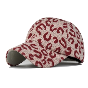 Close-up of red leopard jacquard knit texture on warm thermal ponytail baseball cap