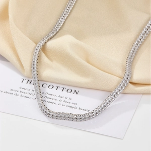 Detailed macro view of double-row tennis necklace with sparkling white zircons on silk
