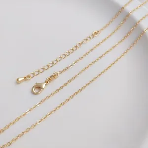 Macro shot of 14K gold plated necklace with lobster clasp and teardrop extension chain