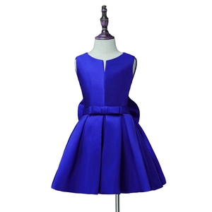 Detail of royal blue sleeveless satin girl dress with waist bow and pleated skirt