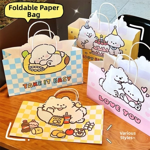 Close-up of cute cartoon puppy paper gift bags with sturdy white rope handles and foldable design