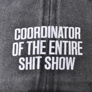 Distressed charcoal cotton baseball cap with COORDINATOR OF THE ENTIRE SHIT SHOW print