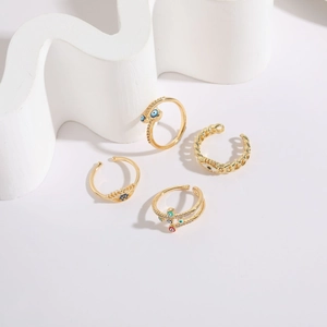 Detailed view of 14K gold plated evil eye rings set with colorful enamel designs