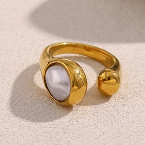 Macro view of adjustable 18K gold plated snake-head ring with an irregular white pearl