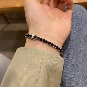 Detail of 4mm black zircon tennis bracelet in S925 sterling silver worn on a wrist