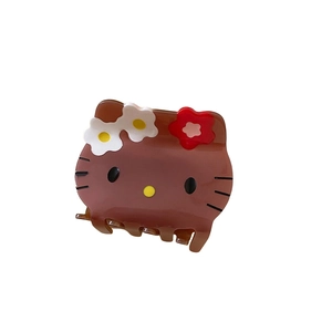Brown acrylic cartoon cat hair claw clip with floral accents on white background