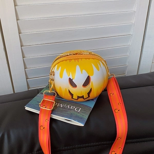 Detail of round pumpkin smiley crossbody bag with adjustable festive patterned wide strap