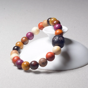Macro detail of colorful wooden prayer beads showing natural wood texture and zen style