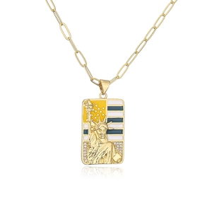 Detail of gold-plated paperclip chain necklace with Statue of Liberty enamel pendant