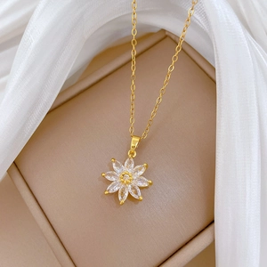 Close-up of a sparkling gold flower pendant necklace with marquise-cut crystals
