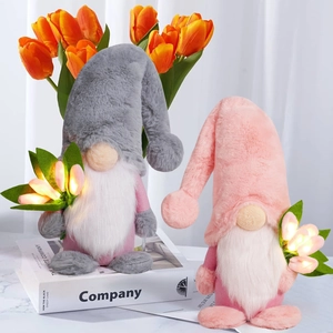 Detail of grey and pink plush gnomes holding warm LED light tulips on books