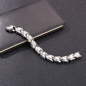 Close-up of a rugged silver stainless steel dragon bone link bracelet on leather