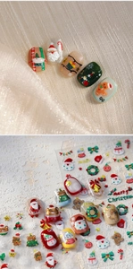 Macro view of 3D Christmas nail stickers with Santa Claus and gingerbread man patterns