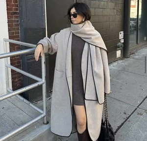 Oatmeal wool coat set featuring contrast black edges and a matching scarf in urban setting
