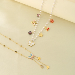 Detailed view of beaded pearl necklace with colorful butterfly and floral charms