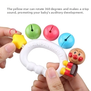Close-up of baby rattle toy with Anpanman character showing rotation and sound functions