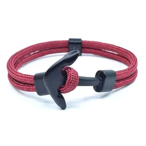 Red nautical anchor bracelet with braided fiber rope and black clasp on white background