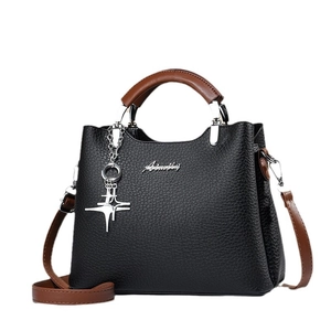 Fashionable black lychee grain handbag for women with brown handles and star charm