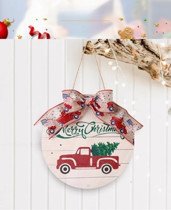 Macro view of round wooden Christmas sign with vintage red truck and festive bow