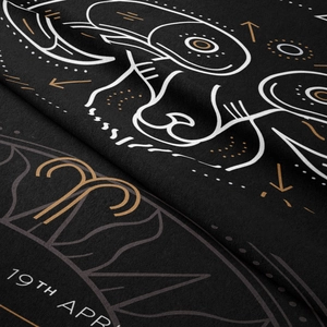 Macro shot of Aries zodiac tapestry showing intricate gold lines and fabric texture