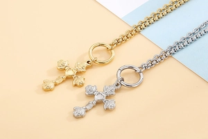 Close-up of heart-centered rose cross pendants in gold and silver stainless steel