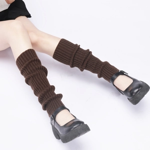 Detail of brown chunky knit leg warmers showing thick ribbed texture and retro style