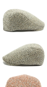 Close-up of mixed tweed texture and metal buckle detail on retro flat ivy caps