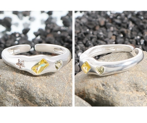 Macro detail of S925 sterling silver ring with yellow star and heart zircon stones