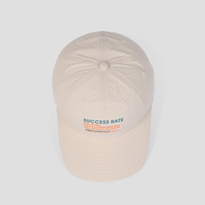 Detailed top view of breathable nylon baseball cap fabric and stitched letter embroidery