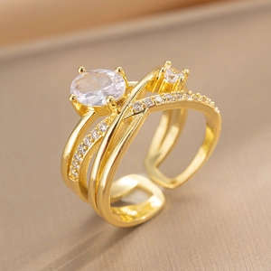 Minimalist gold plated adjustable cross ring featuring a layered oval cubic zirconia