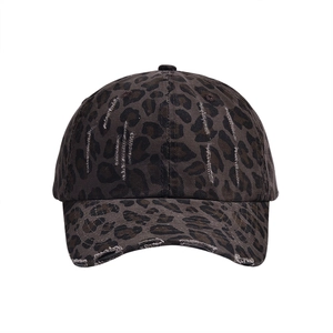 Detailed view of Y2K distressed leopard print baseball cap with washed denim texture