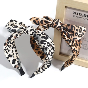 Close-up of two leopard print bow headbands in dark and light shades with black edges