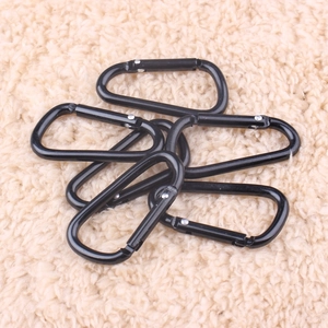Set of 6 black D-ring carabiners with spring gates on a textured beige background