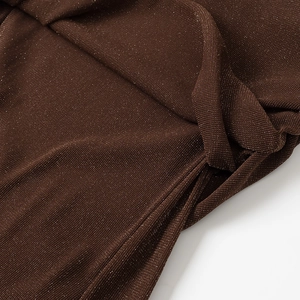 Detailed macro view of the brown knitted fabric with shimmering metallic threads texture