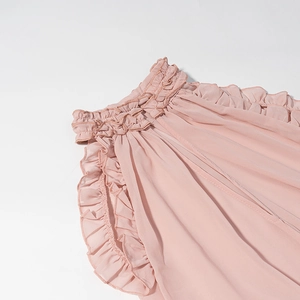 Detail shot of the ruffled neckline and stitching on a pink chiffon vacation set