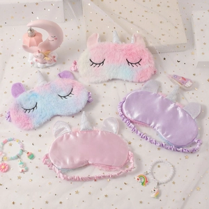 Cute plush unicorn sleep masks in rainbow and silk styles with silver horn details