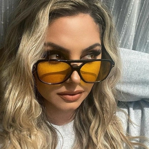 Retro pilot sunglasses with black frame, yellow lenses, and gold T-shape metal accents