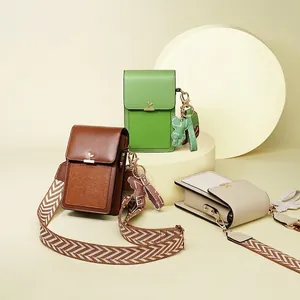 Mini crossbody phone bags in three colors with wide strap and cartoon bear pendant
