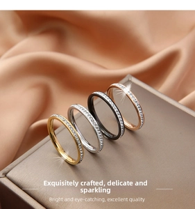 Detail of four-color titanium steel eternity rings with inlaid rhinestones on satin fabric