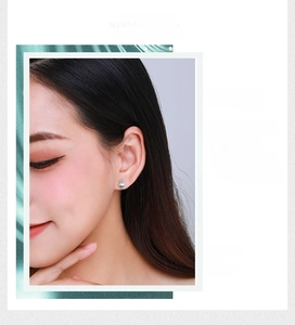 Close-up of vintage S925 sterling silver palm stud earring worn by a model
