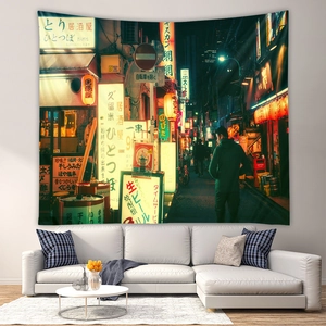 Detail of bohemian cityscape tapestry showing neon lights above a modern white sofa