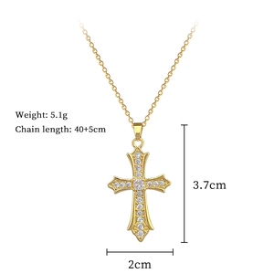 Macro detail of a gold cross pendant necklace with weight and size specifications