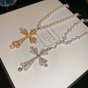 Elegant pearl cross necklaces in gold and silver finish with sparkling zircons and white pearls