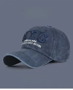 Detailed embroidery of NYC logo on vintage washed navy blue cotton baseball cap texture