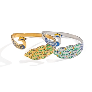 Vintage peacock open cuff bangle in gold and silver plating with colorful enamel feathers