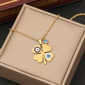 Golden flower pendant necklace with evil eye charms in a jewelry box